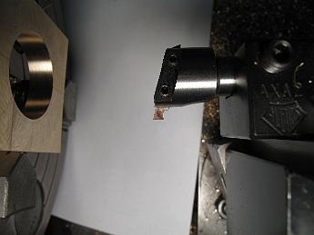  Boring the strap with a special profile tool which will allow us to turn an inside groove.  The small HSS toolbit is held in a small boring bar, which is held in the Aloris AXA quick-change tool holder.